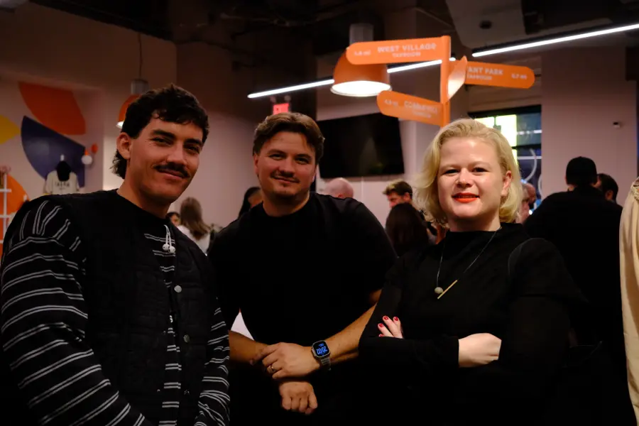 Three attendees posing for the camera